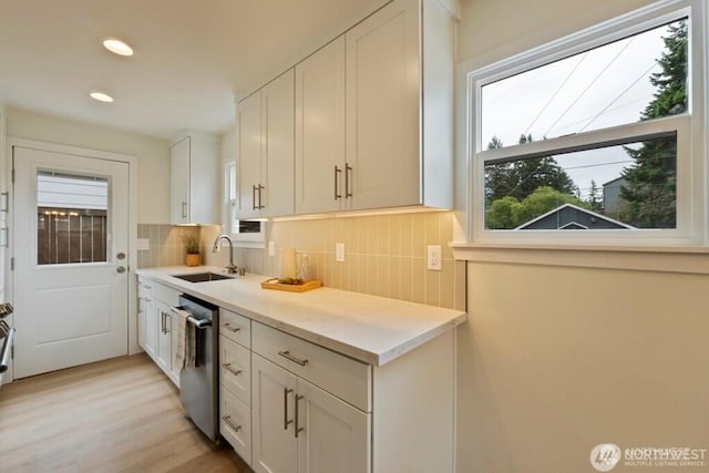 12302 5th Ave NE, Seattle, WA 98125 - kitchen with dishwasher, backsplash, light countertops, white cabinets, and recessed lighting