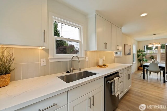 12302 5th Ave NE, Seattle, WA 98125 - kitchen with stainless steel dishwasher, white cabinets, light wood-style flooring, tasteful backsplash, and recessed lighting