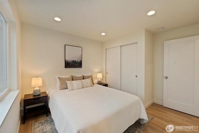 12302 5th Ave NE, Seattle, WA 98125 - bedroom with light wood-style flooring, a closet, and recessed lighting