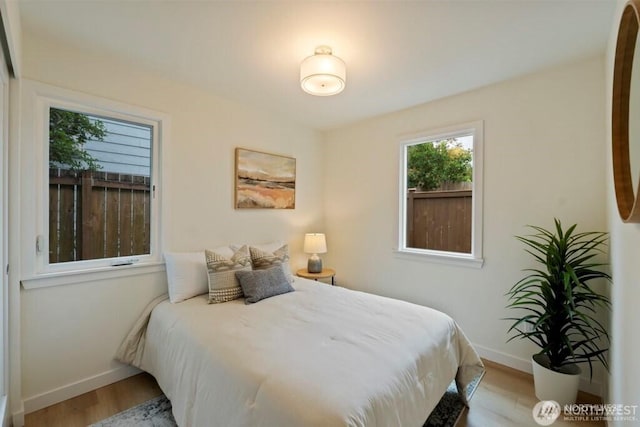 12302 5th Ave NE, Seattle, WA 98125 - bedroom with baseboards and light wood finished floors