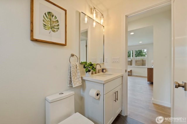 12302 5th Ave NE, Seattle, WA 98125 - bathroom featuring vanity, wood finished floors, and recessed lighting