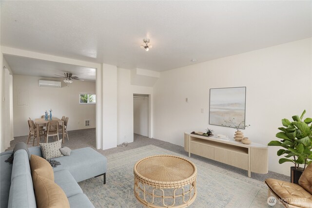 812 Duffy St, Aberdeen, WA 98520 - living room with light carpet, a wall mounted air conditioner, and a ceiling fan
