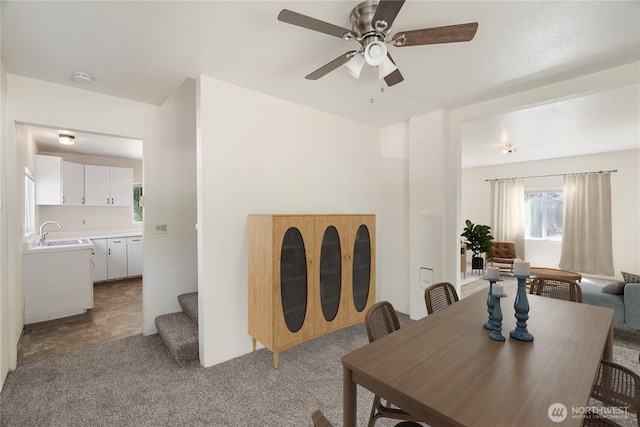 812 Duffy St, Aberdeen, WA 98520 - carpeted dining area with a ceiling fan and stairway