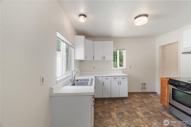 812 Duffy St, Aberdeen, WA 98520 - kitchen featuring electric stove, stone finish floors, plenty of natural light, and light countertops