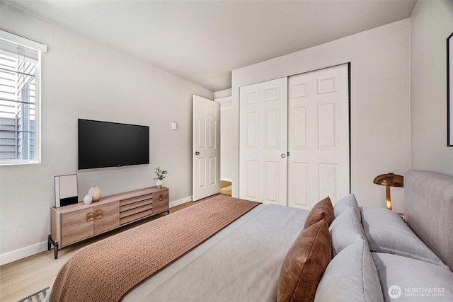 9822 NE 122nd St Unit U201, Kirkland, WA 98034 - bedroom with light wood-style floors and a closet