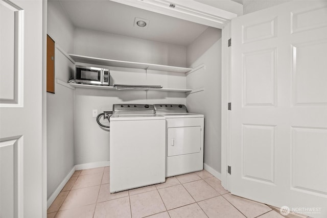9822 NE 122nd St Unit U201, Kirkland, WA 98034 - washroom featuring independent washer and dryer and light tile patterned flooring
