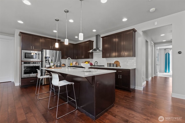 23422 26th Ave SE, Bothell, WA 98021 - kitchen with stainless steel appliances, wall chimney exhaust hood, tasteful backsplash, light countertops, and dark brown cabinetry