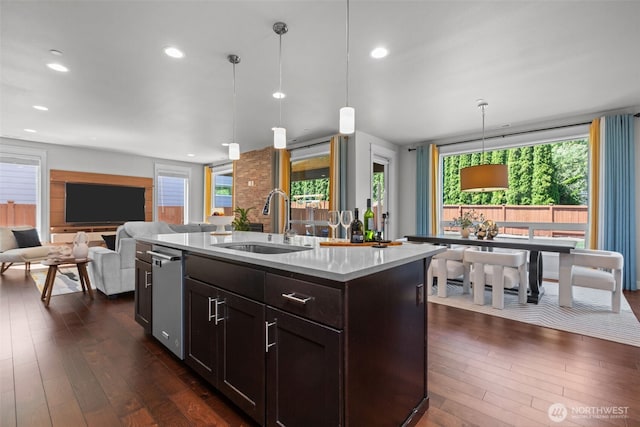 23422 26th Ave SE, Bothell, WA 98021 - kitchen with dark wood finished floors, pendant lighting, dark brown cabinetry, a center island with sink, and open floor plan