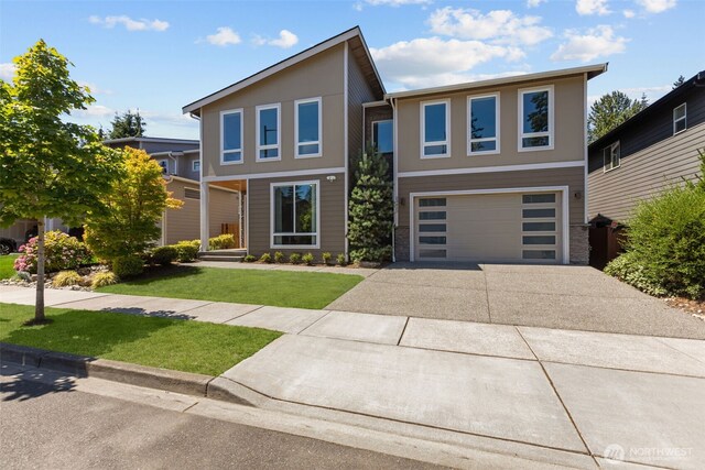 23422 26th Ave SE, Bothell, WA 98021 - modern home with concrete driveway, an attached garage, and a front yard