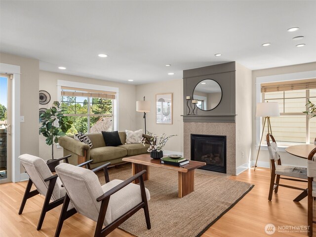 3011 Humes Pl W, Seattle, WA 98119 - living area featuring light wood-style flooring, a tiled fireplace, and recessed lighting