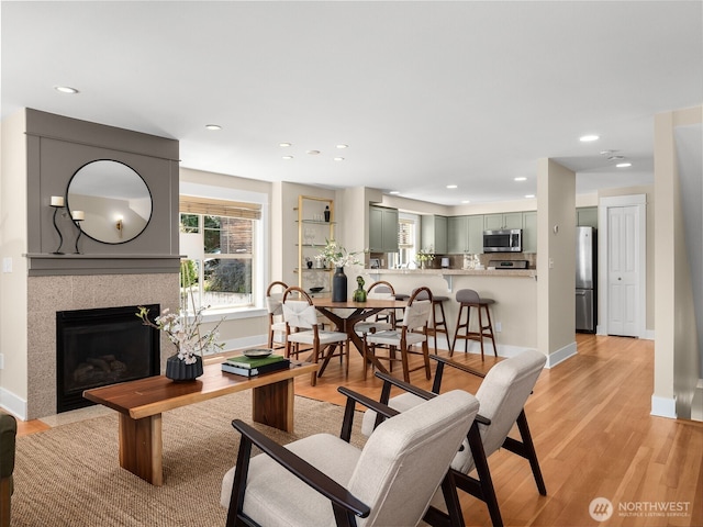 3011 Humes Pl W, Seattle, WA 98119 - living area with recessed lighting, light wood-type flooring, and a fireplace with flush hearth