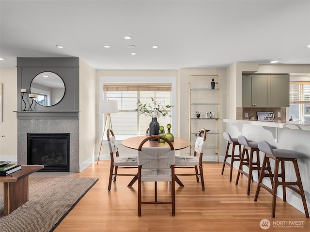 3011 Humes Pl W, Seattle, WA 98119 - dining area featuring recessed lighting, light wood-style floors, and a glass covered fireplace