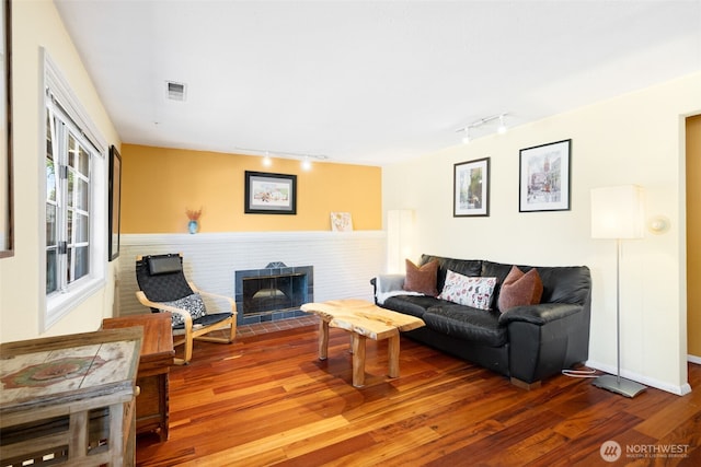 1524 30th Ave, Seattle, WA 98122 - living room featuring track lighting, wood finished floors, and a fireplace