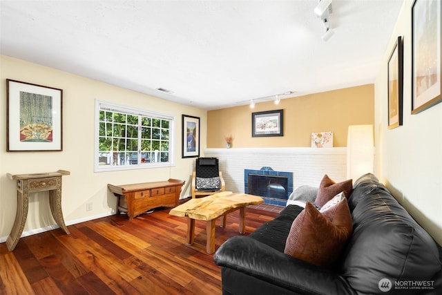 1524 30th Ave, Seattle, WA 98122 - living room featuring rail lighting, wood finished floors, and a fireplace