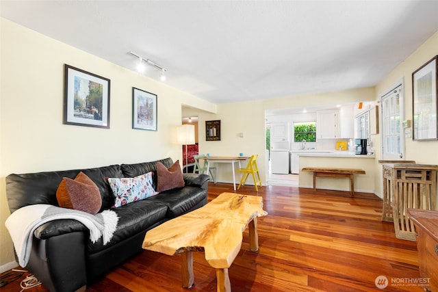 1524 30th Ave, Seattle, WA 98122 - living area with wood finished floors, washer / dryer, and track lighting