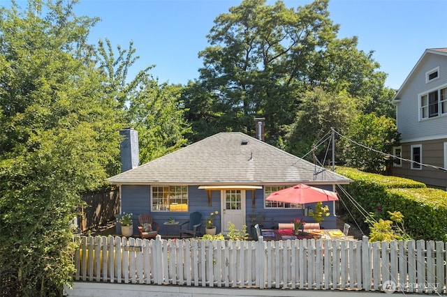 1524 30th Ave, Seattle, WA 98122 - bungalow featuring a fenced front yard, a chimney, a shingled roof, and outdoor lounge area