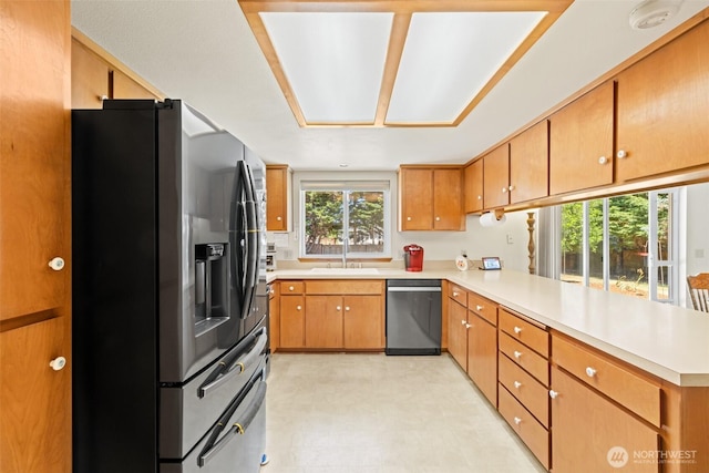 50 Steve Pl, Sequim, WA 98382 - kitchen with appliances with stainless steel finishes, a peninsula, light countertops, light floors, and brown cabinetry