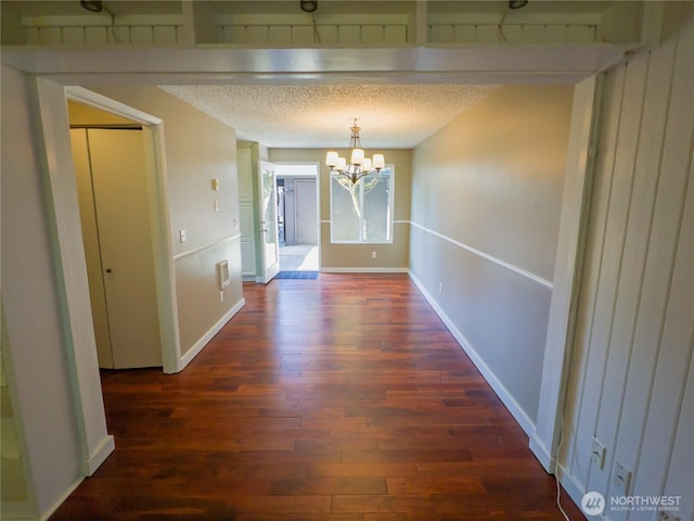 1717 150th Ave SE Unit 31, Bellevue, WA 98007 - unfurnished dining area with a chandelier, wood finished floors, and a textured ceiling