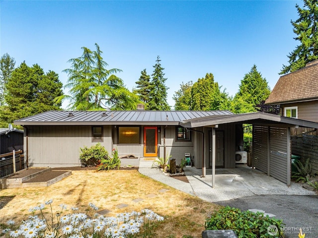 10032 35th Ave NE, Seattle, WA 98125 - view of front of property with a garden, a standing seam roof, an attached carport, and a metal roof
