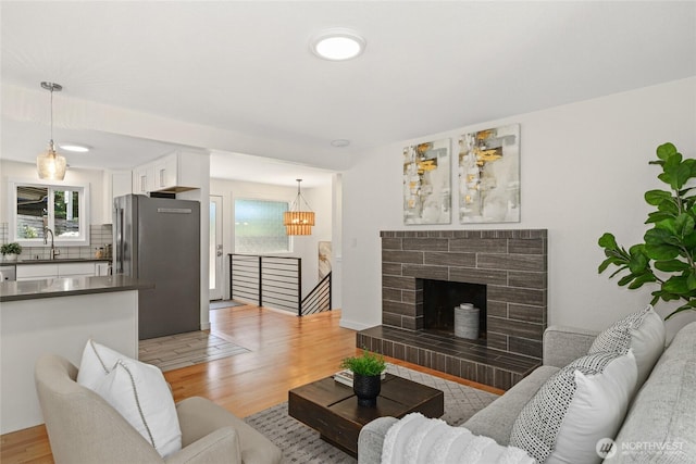 10032 35th Ave NE, Seattle, WA 98125 - living room featuring light wood-type flooring and a tiled fireplace