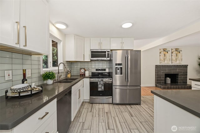 10032 35th Ave NE, Seattle, WA 98125 - kitchen with appliances with stainless steel finishes, dark countertops, decorative backsplash, and white cabinets