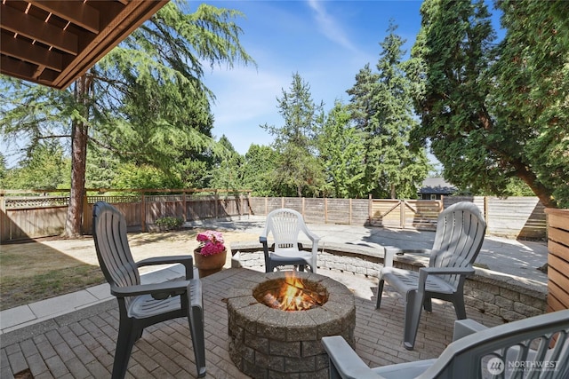 10032 35th Ave NE, Seattle, WA 98125 - fenced backyard featuring an outdoor fire pit and a patio area