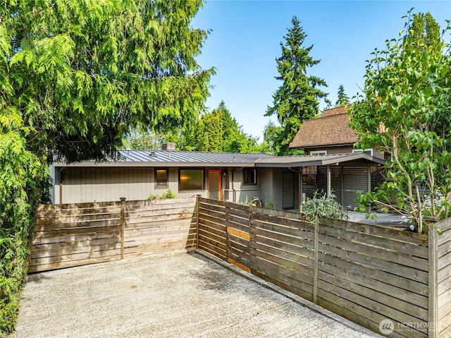 10032 35th Ave NE, Seattle, WA 98125 - view of front facade featuring a chimney and a metal roof