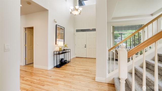 17303 SE 185th St, Renton, WA 98058 - foyer entrance featuring stairs, wood finished floors, a chandelier, and a high ceiling