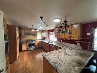 29024 38th Ave S, Auburn, WA 98001 - kitchen featuring range, a peninsula, dishwasher, light wood finished floors, and under cabinet range hood