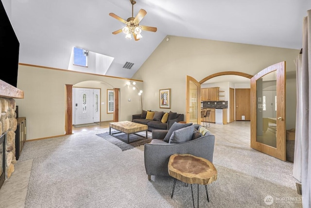 1307 Birchwood Dr, Everson, WA 98247 - living area with a ceiling fan, light colored carpet, a skylight, arched walkways, and high vaulted ceiling