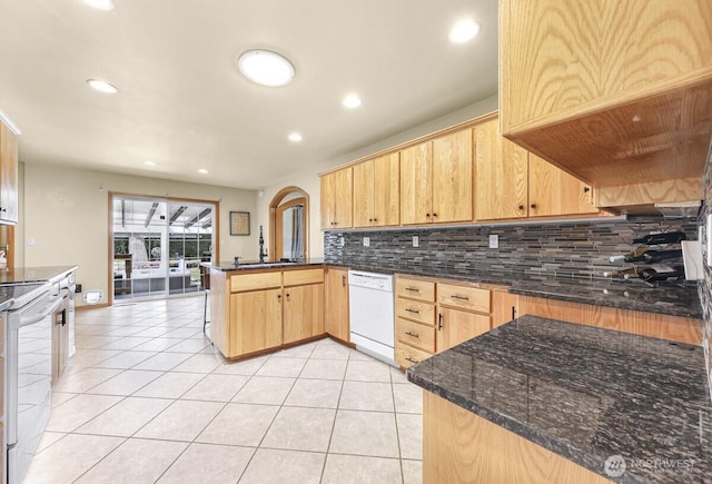 1307 Birchwood Dr, Everson, WA 98247 - kitchen featuring dishwasher, a peninsula, range with electric cooktop, arched walkways, and tasteful backsplash