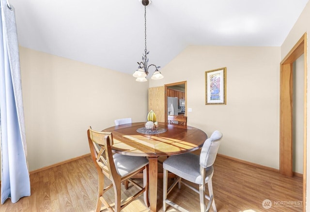 1307 Birchwood Dr, Everson, WA 98247 - dining space with a chandelier, vaulted ceiling, and light wood-type flooring