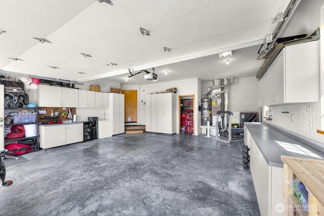 1307 Birchwood Dr, Everson, WA 98247 - garage featuring a garage door opener and water heater