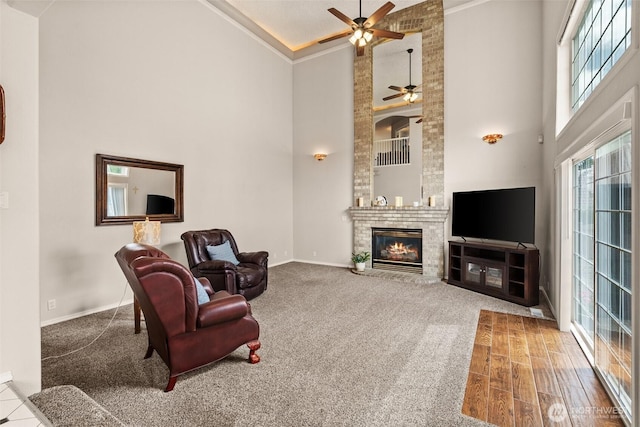 4618 51st Street Ct E, Tacoma, WA 98443 - sitting room featuring a towering ceiling, a ceiling fan, ornamental molding, a fireplace, and carpet flooring
