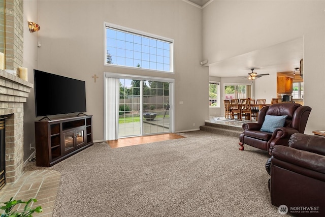 4618 51st Street Ct E, Tacoma, WA 98443 - living room featuring a brick fireplace, carpet, a towering ceiling, and ceiling fan