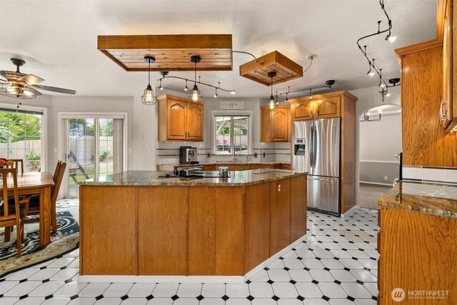 4618 51st Street Ct E, Tacoma, WA 98443 - kitchen featuring stainless steel fridge with ice dispenser, light flooring, ceiling fan, and brown cabinetry
