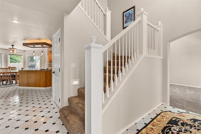 4618 51st Street Ct E, Tacoma, WA 98443 - stairway with ceiling fan, arched walkways, a textured ceiling, and carpet