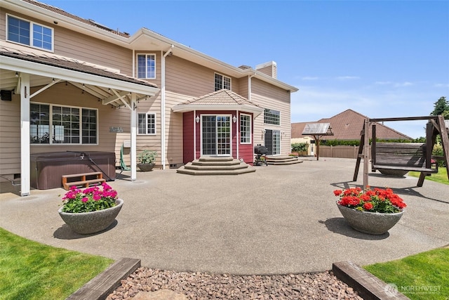 4618 51st Street Ct E, Tacoma, WA 98443 - rear view of property with a chimney, a patio, and a hot tub