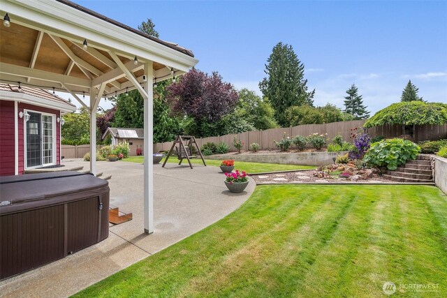 4618 51st Street Ct E, Tacoma, WA 98443 - fenced backyard with a hot tub, a playground, a patio area, and a shed
