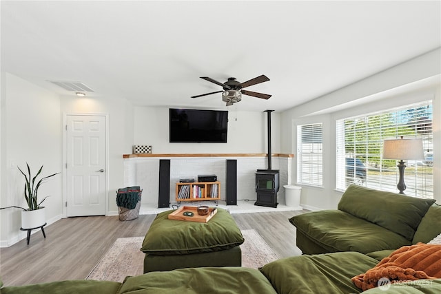 209 4th Ave N, Algona, WA 98001 - living area featuring a wood stove, ceiling fan, and wood finished floors