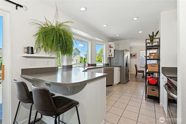 209 4th Ave N, Algona, WA 98001 - kitchen featuring appliances with stainless steel finishes, open shelves, a peninsula, dark countertops, and recessed lighting