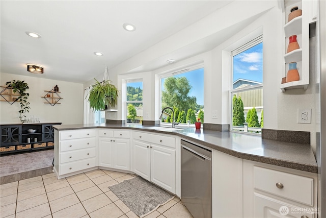 209 4th Ave N, Algona, WA 98001 - kitchen featuring dishwasher, white cabinetry, light tile patterned flooring, dark countertops, and a peninsula