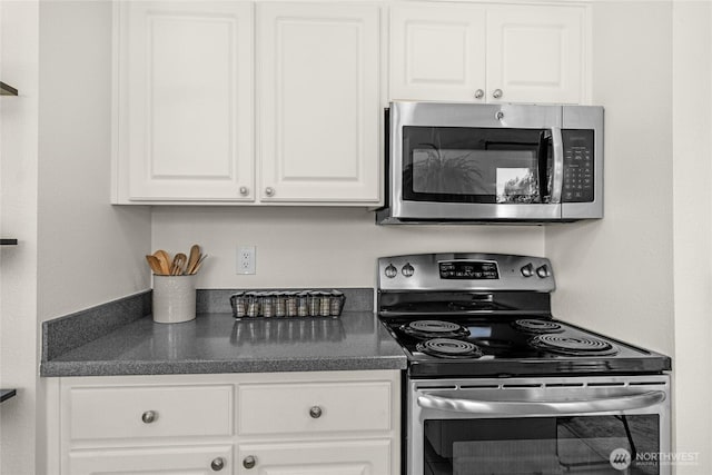 209 4th Ave N, Algona, WA 98001 - kitchen featuring appliances with stainless steel finishes, dark countertops, and white cabinets