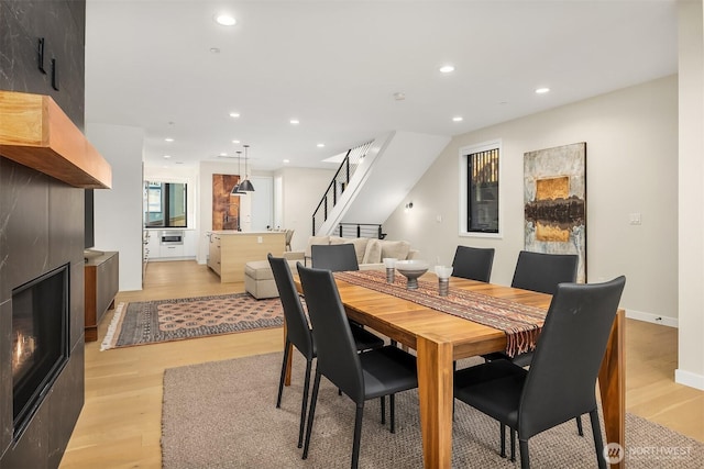 330 3rd Ave S Unit C, Kirkland, WA 98033 - dining room featuring stairs, light wood-type flooring, recessed lighting, and a large fireplace