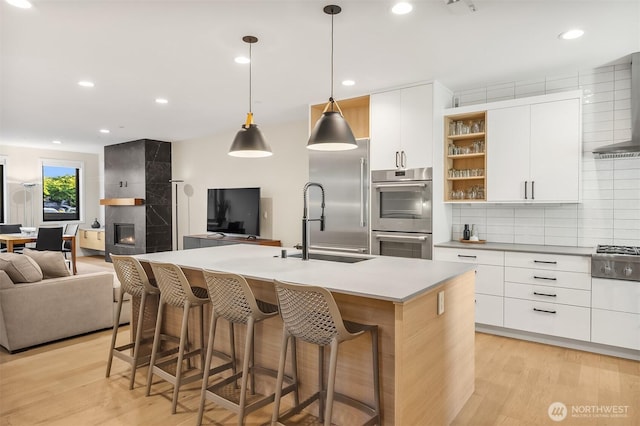 330 3rd Ave S Unit C, Kirkland, WA 98033 - kitchen with stainless steel appliances, open shelves, modern cabinets, decorative backsplash, and open floor plan
