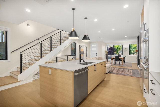 330 3rd Ave S Unit C, Kirkland, WA 98033 - kitchen with stainless steel dishwasher, modern cabinets, light brown cabinetry, light wood-type flooring, and recessed lighting