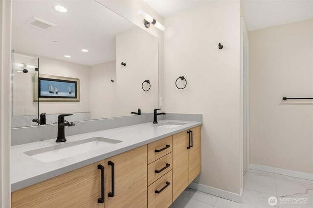 330 3rd Ave S Unit C, Kirkland, WA 98033 - bathroom featuring marble look tile flooring, double vanity, and recessed lighting