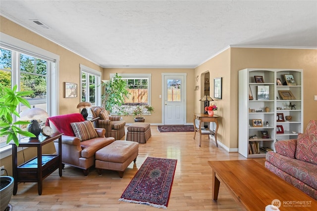 541 75th Way NE, Olympia, WA 98506 - living room featuring light wood-type flooring, ornamental molding, a textured ceiling, and arched walkways