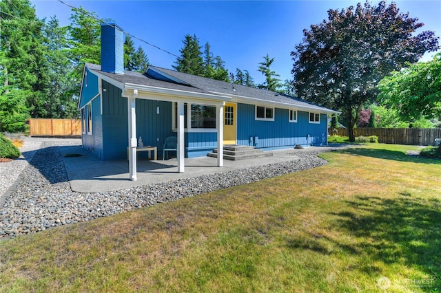 541 75th Way NE, Olympia, WA 98506 - back of house featuring a chimney, board and batten siding, and a patio area