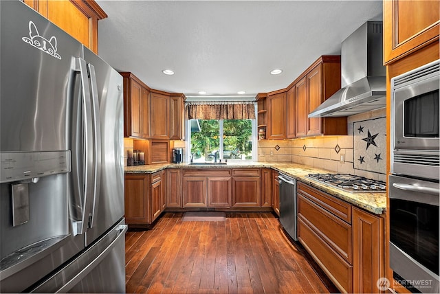 21410 SE 265th Pl, Maple Valley, WA 98038 - kitchen with appliances with stainless steel finishes, wall chimney exhaust hood, brown cabinetry, dark wood-style flooring, and recessed lighting